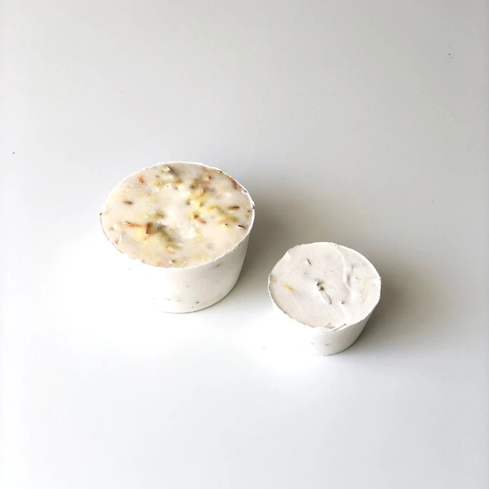 Naked bars of Calendula hair and body soap on a white background