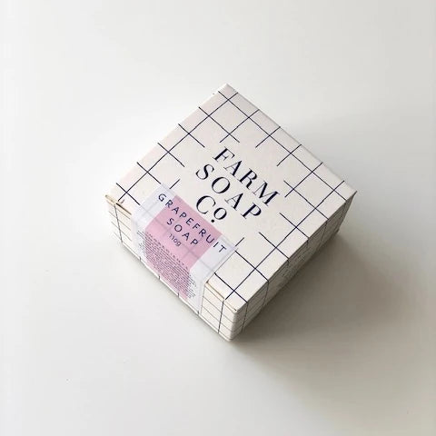 A plain background with 110g box of Grapefruit hair and body soap by Farm Soap Co