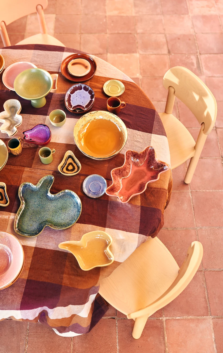 HKLIVING Ceramic Shell Plate in Sienna on a white background on a laid table amongst other ceramics from the collection