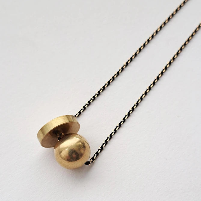 Hiku Necklace featuring a heavy brass ball and thick brass disc on a black brass chain by Brass and Bold