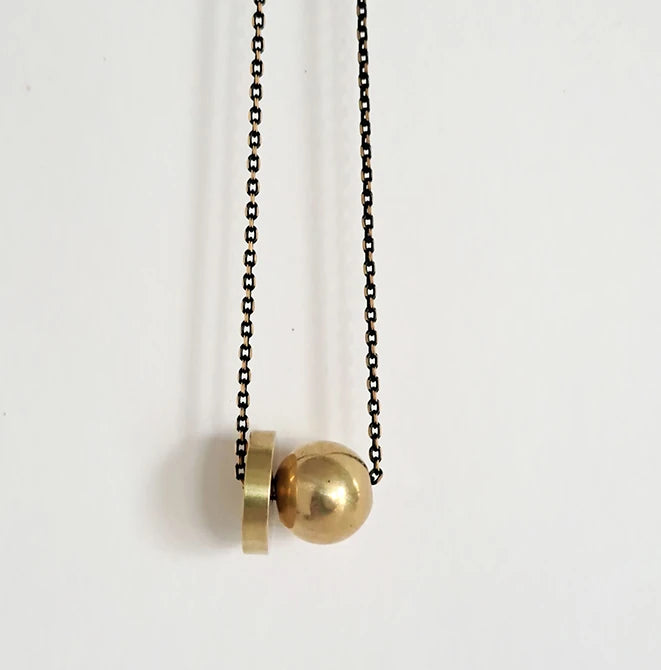 Hiku Necklace featuring a heavy brass ball and thick brass disc on a black brass chain by Brass and Bold