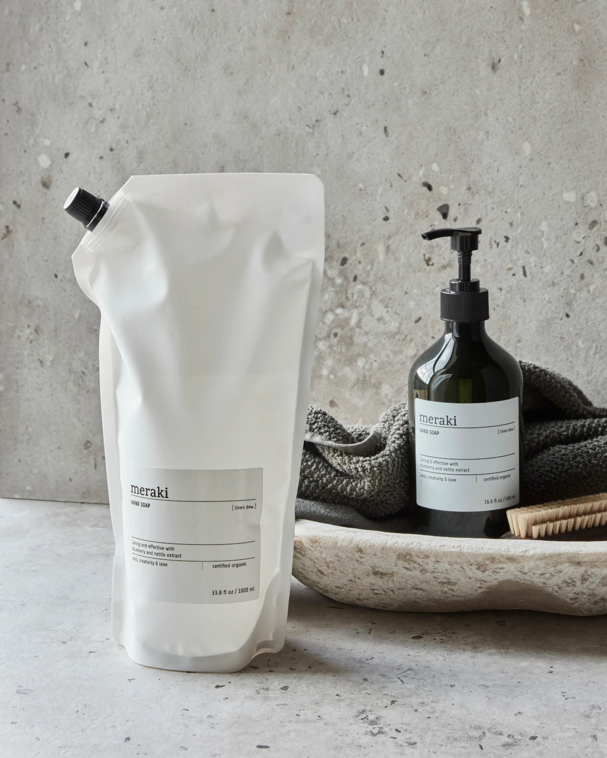 Meraki Hand Soap Linen Dew - 1000ml Refill Bag in a bathroom next to the pump action bottle