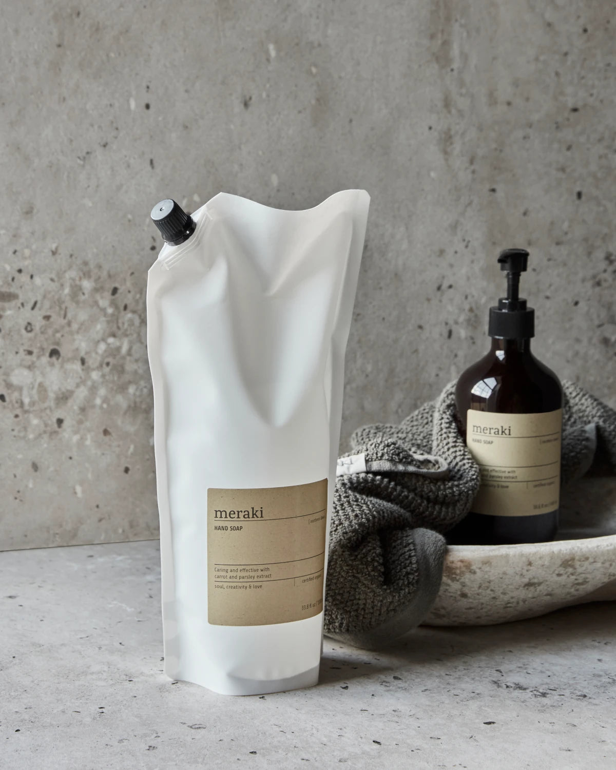 Meraki Hand Soap Northern Dawn - 1000ml Refill Bag in a bathroom next to the pump action bottle