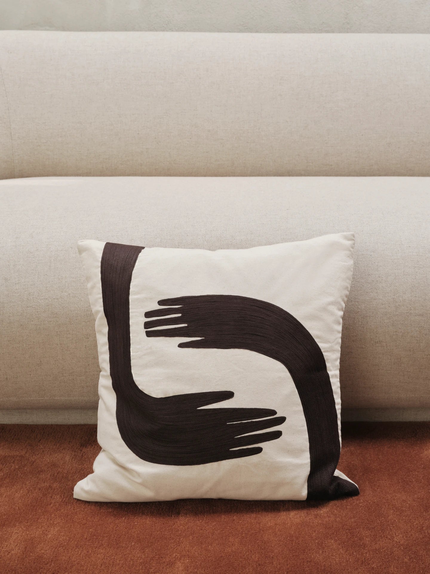 Pose cushion in front of a sofa by ferm Living | Lifestory