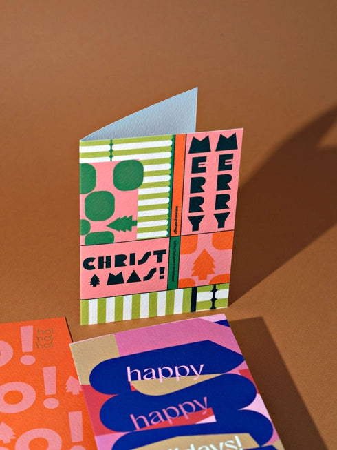 Seoul Merry Christmas Card by The Completist standing up next to other cards