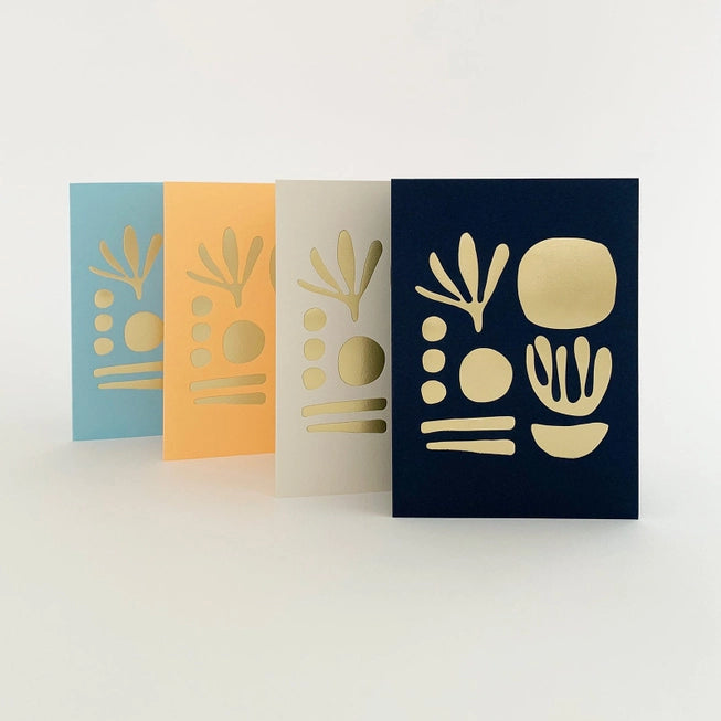 Tom Pigeon seaweed cards family featuring a brass foiled geometric design on different coloured cards