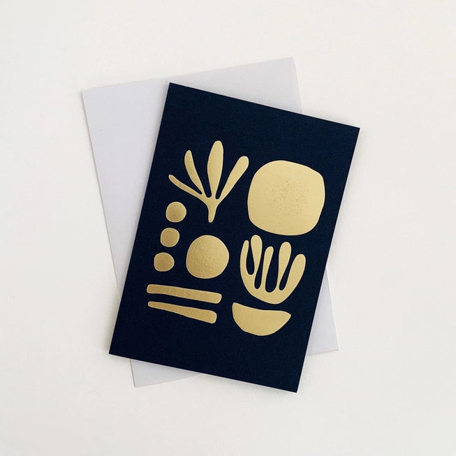 Tom Pigeon seaweed card featuring a brass foiled geometric design on a navy blue background