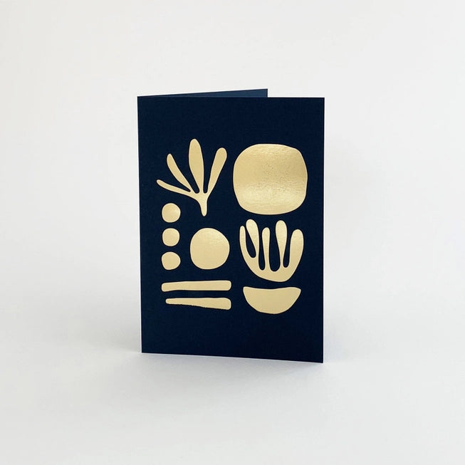 Tom Pigeon seaweed card featuring a brass foiled geometric design on a navy blue background