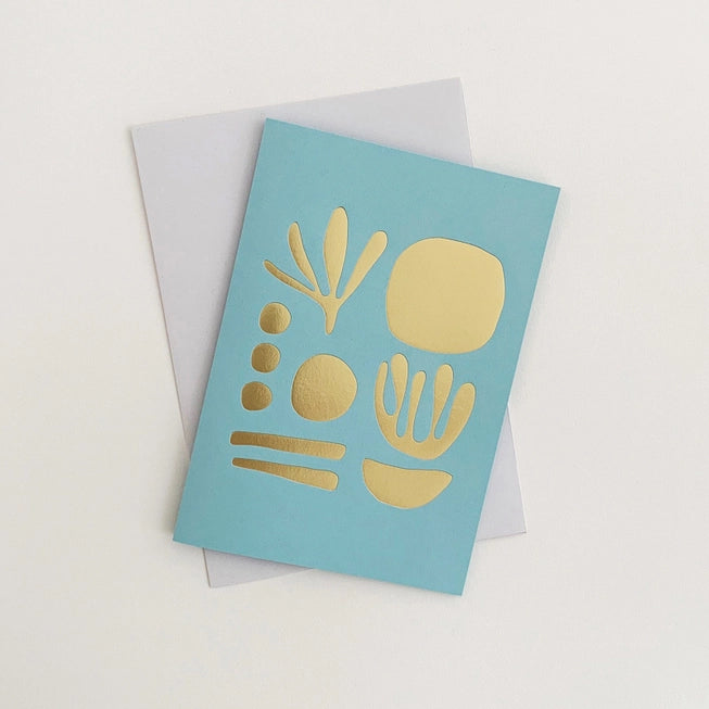 Tom Pigeon seaweed card featuring a brass foiled geometric design on a sky blue background