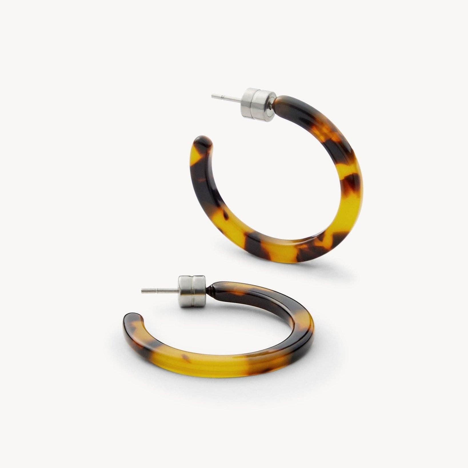 MACHETE Mini Hoops in Tortoise acetate flat on a white background side angle