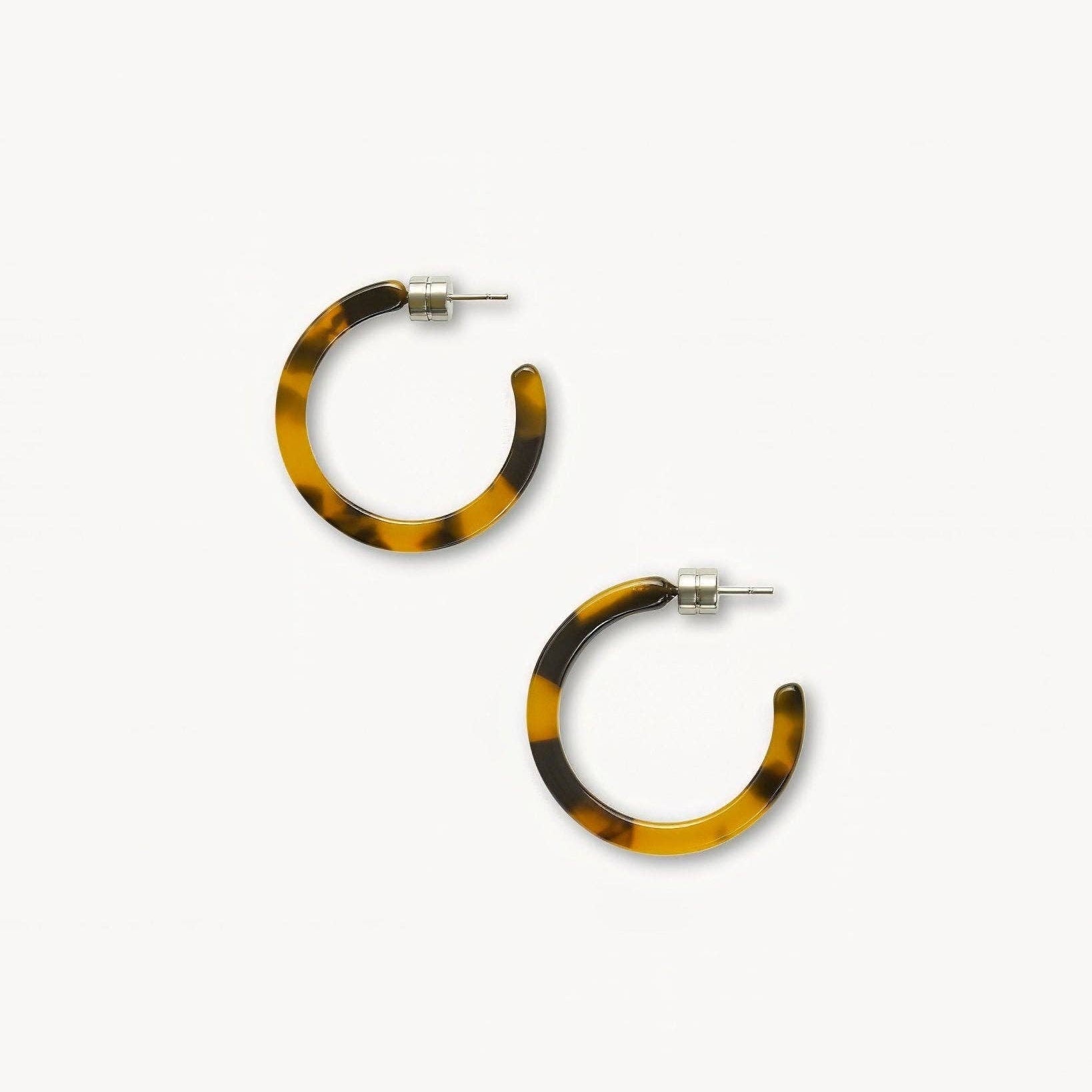 MACHETE Mini Hoops in Tortoise acetate flat on a white background